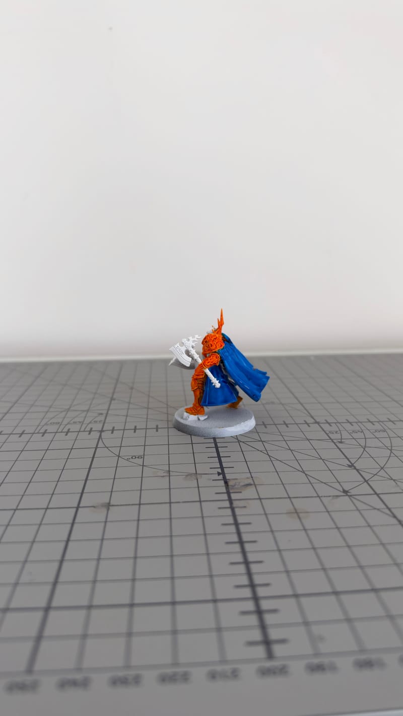 The Reclusian with its orange armour and blue cloak painted, seen from the back.